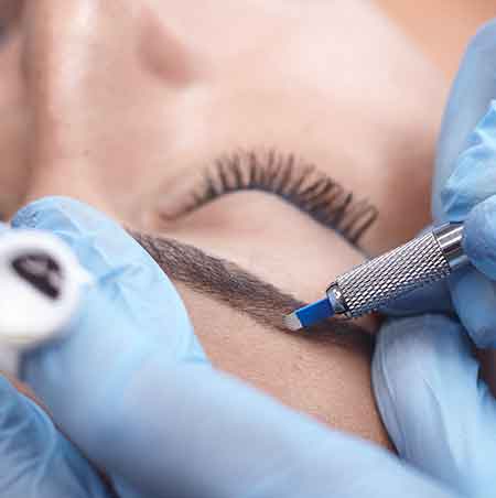Woman Getting Microblading done to her brows Woman Getting Microblading done to her brows